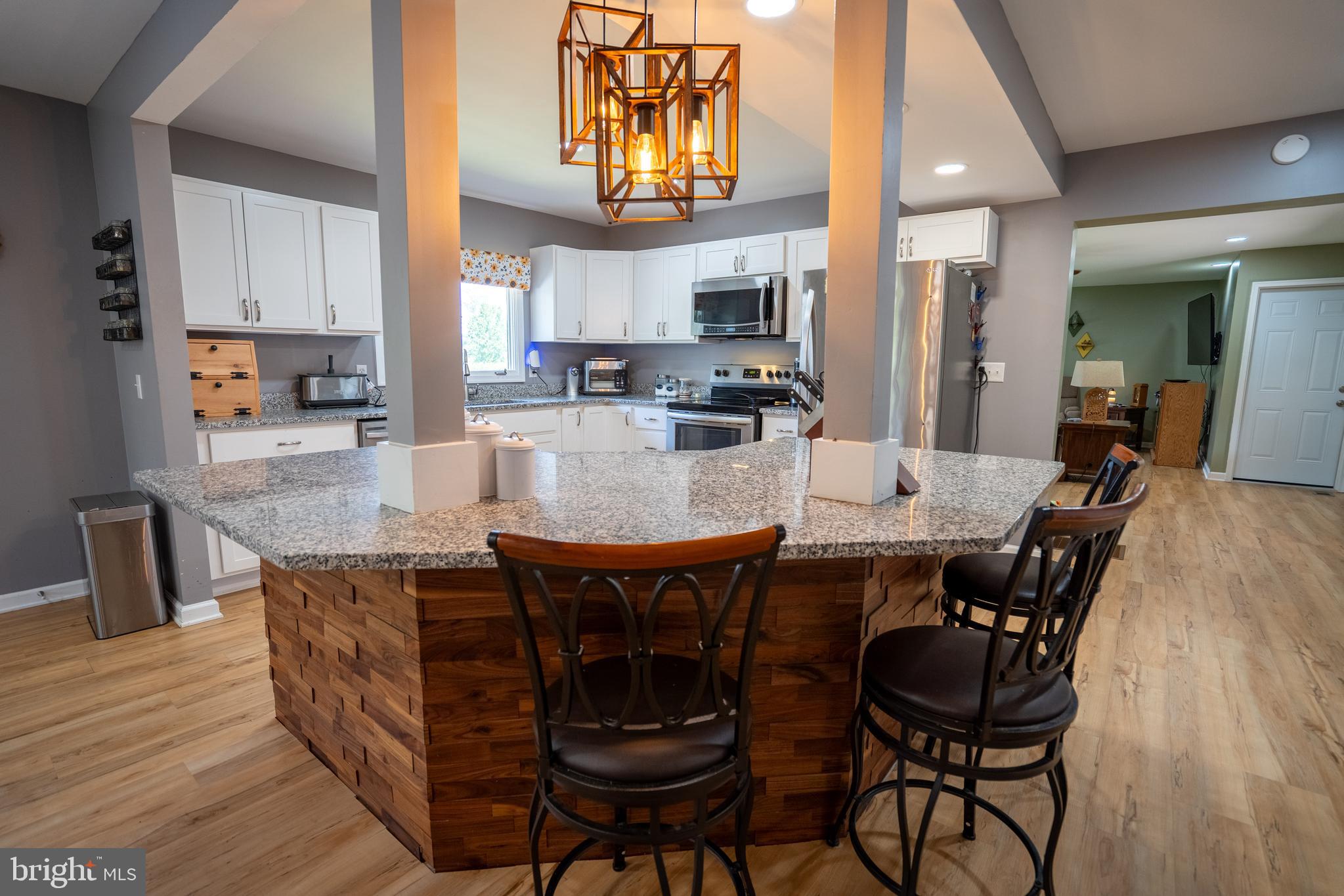 474 Potter Road Hedgesville, WV 25427 - Photo 6 of 40 a view of a dining room with furniture and wooden floor