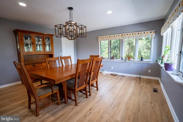 a view of a dining room with furniture wooden floor and chandelier