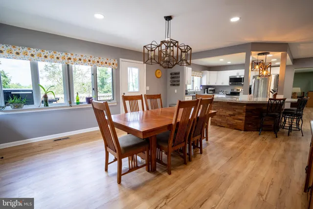 a view of a dining room with furniture wooden floor and chandelier