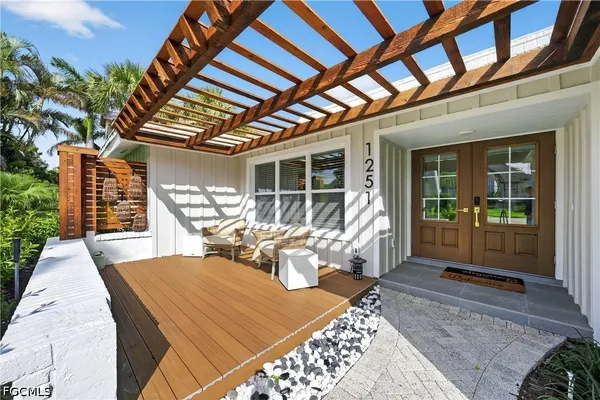 a view of a patio with table and chairs and potted plants