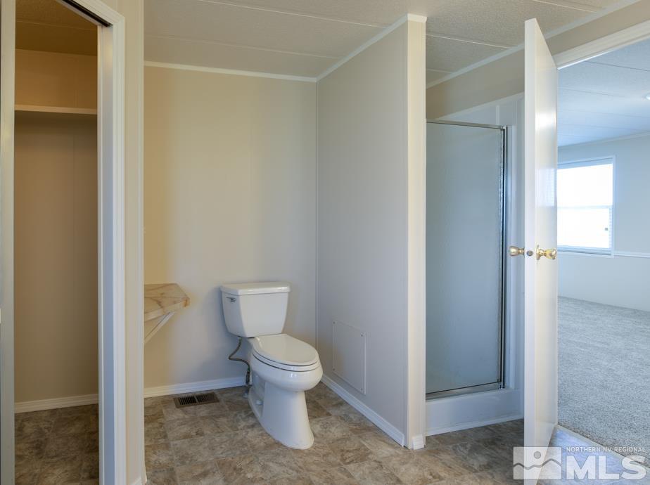 2140 Soda Lake Road Fallon, NV 89406 - Photo 13 of 22 a white toilet sitting next to a bathroom sink