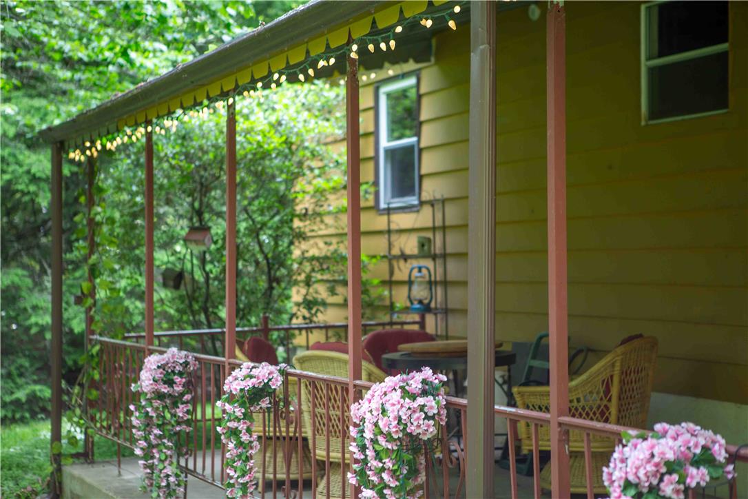 8 Cross Rds Drive Jim Thorpe, PA 18229 - Photo 21 of 32 An inviting front porch with decorative string lights offers a serene setting for outdoor relaxation.