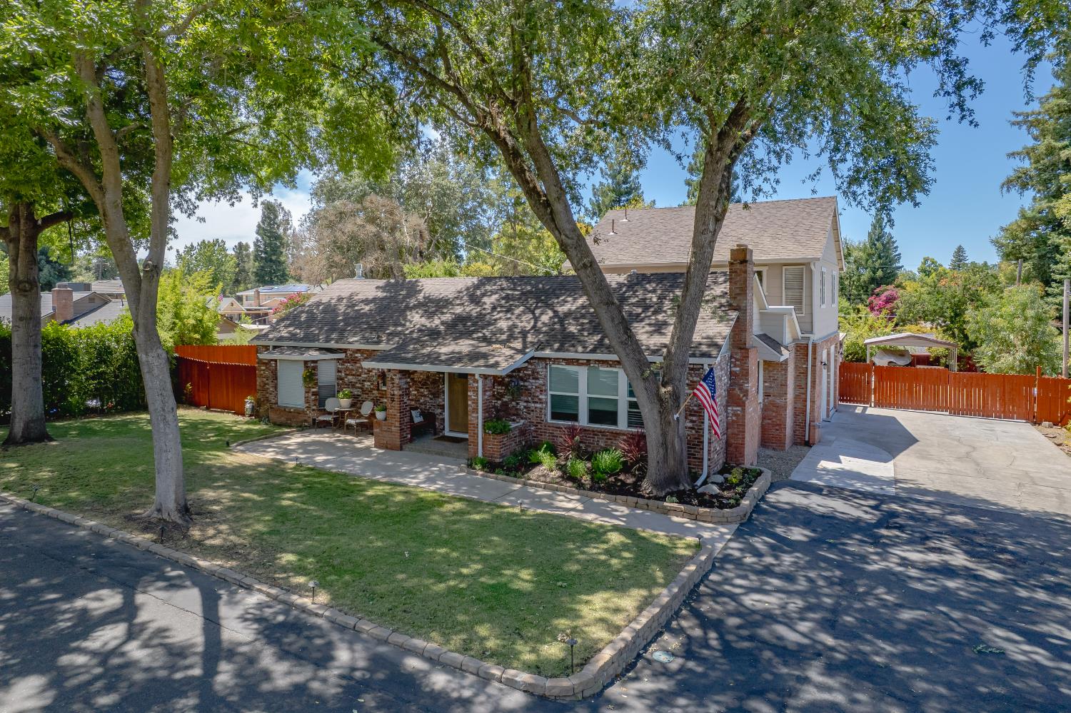a view of a house with backyard garden and sitting area