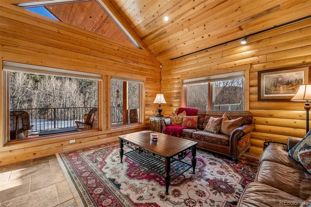a living room with furniture and a floor to ceiling window