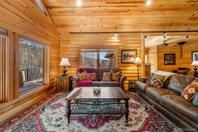 a living room with furniture a rug and a chandelier