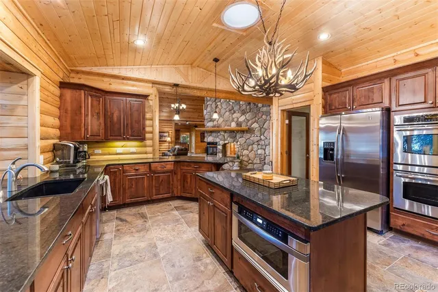 a kitchen with granite countertop a sink and cabinets
