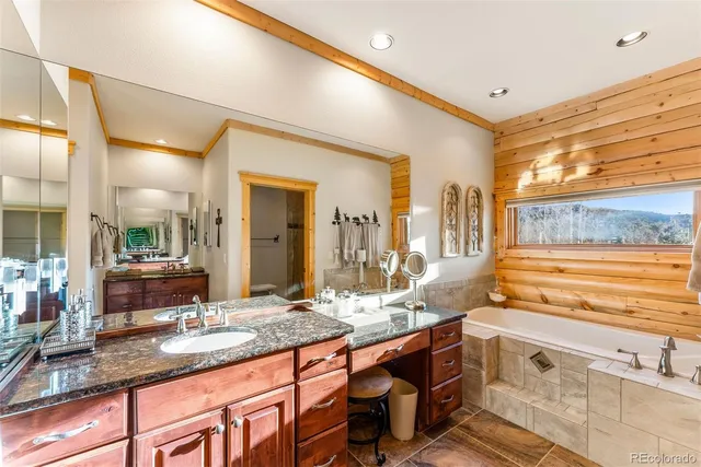 a spacious bathroom with a granite countertop sink and a large mirror