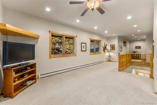a view of a livingroom with furniture and a flat screen tv