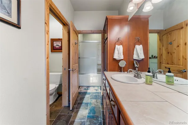 a bathroom with a double vanity sink and a mirror