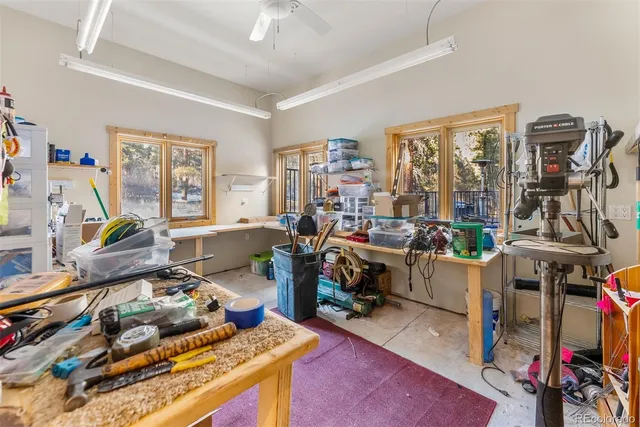 a living room with furniture a flat screen tv and a floor to ceiling window