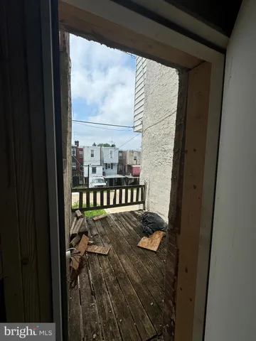 a view of a balcony with furniture and floor to ceiling window