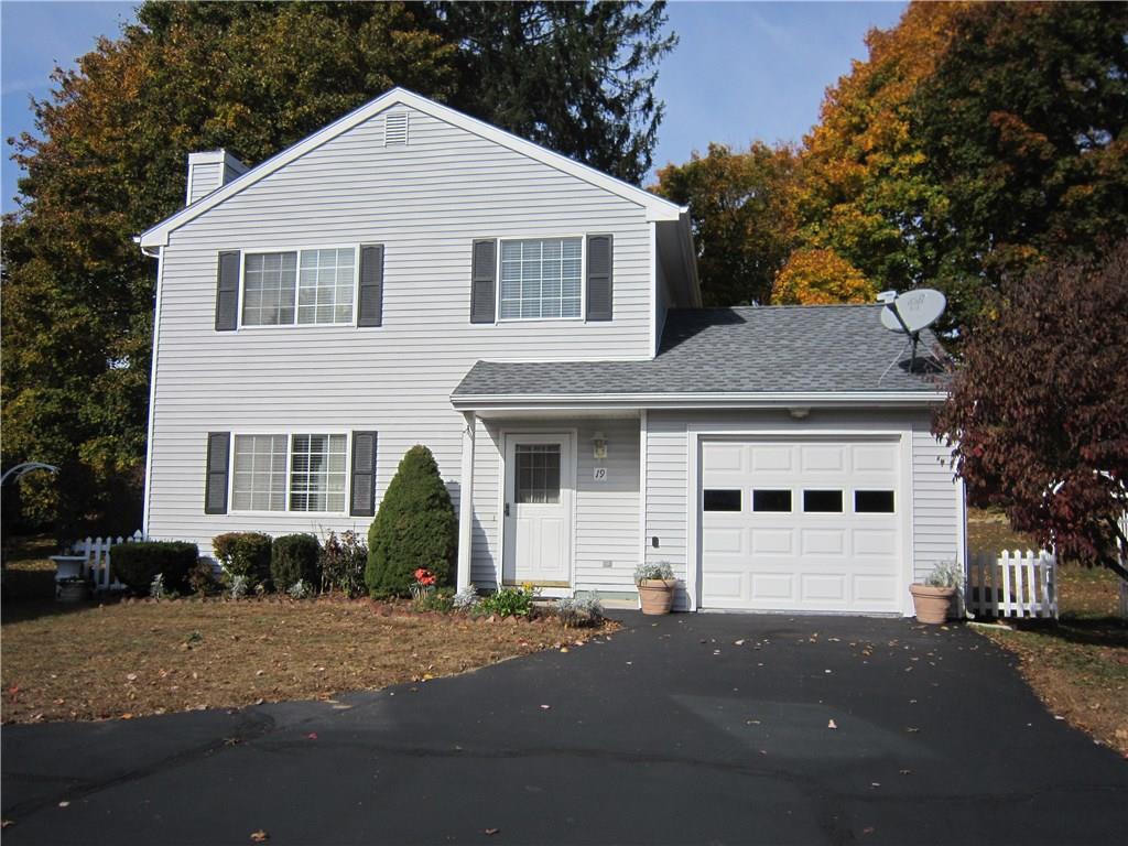a view of a white house with a street