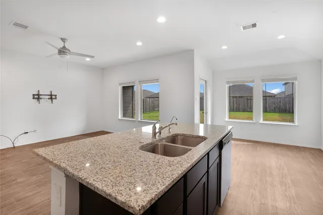 a kitchen with a sink dishwasher and a granite counter top
