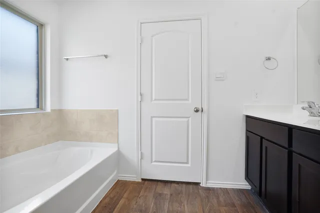 a bathroom with a bathtub and a sink