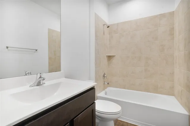 a bathroom with a sink a toilet and bathtub