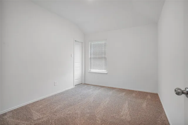 a view of an empty room and a window