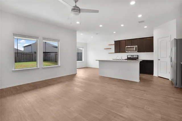 a view of kitchen with stainless steel appliances a refrigerator and a microwave