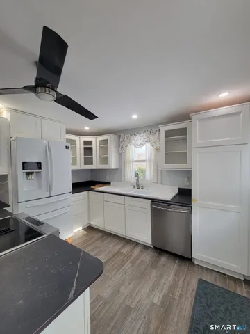 a large kitchen with a stove a sink and a refrigerator