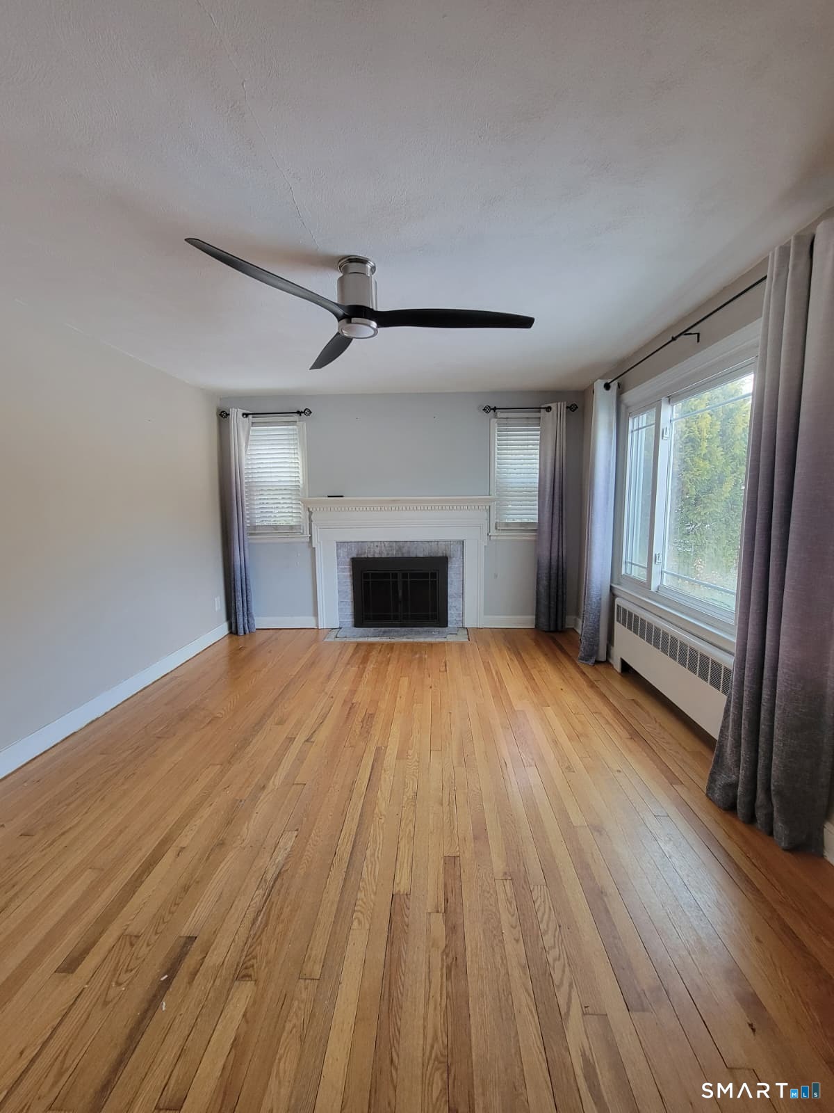 895 Pleasant Valley Road South Windsor, CT 06074 - Photo 9 of 15 a view of empty room with wooden floor and fireplace