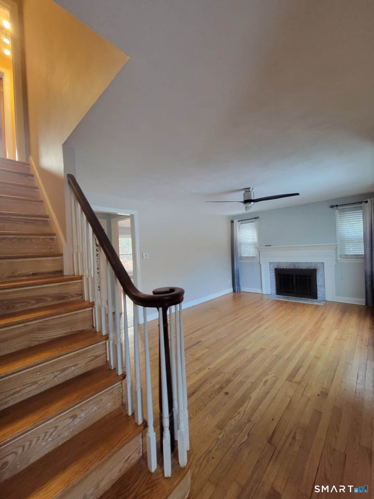895 Pleasant Valley Road South Windsor, CT 06074 - Photo 10 of 15 a view of empty room with wooden floor and fireplace