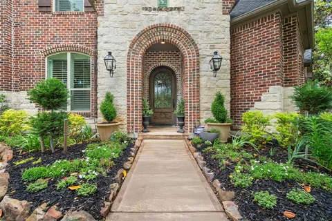 a front view of a house with a garden