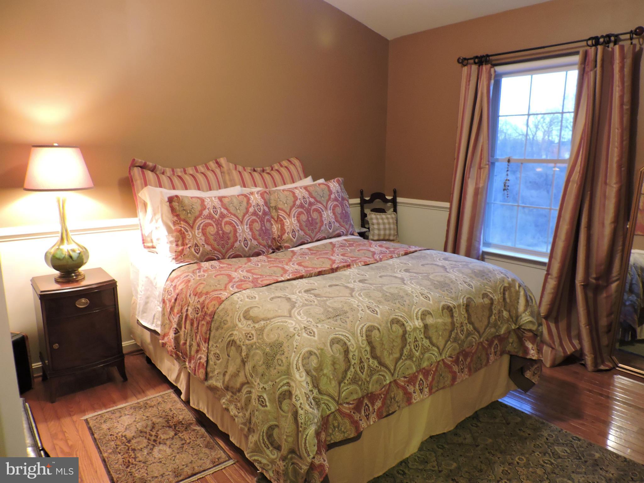2448 Rippling Brook Road Frederick, MD 21701 - Photo 23 of 30 a bed sitting in a bedroom next to a window