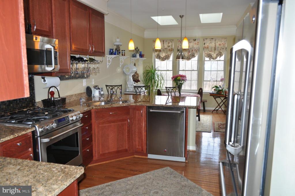 2448 Rippling Brook Road Frederick, MD 21701 - Photo 8 of 30 a kitchen with stainless steel appliances granite countertop a granite counter tops and a view of living room