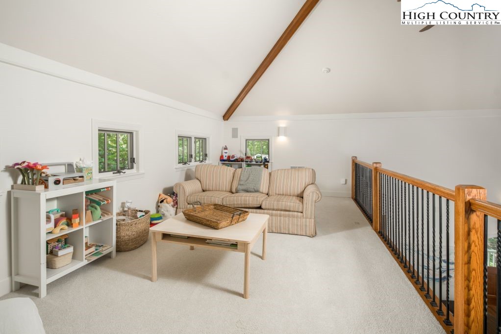 509 Twin Rivers Drive Boone, NC 28607 - Photo 8 of 33 a living room with furniture and a book shelf