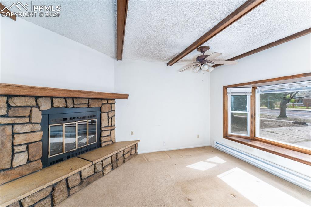 2818 Templeton Gap Road Colorado Springs, CO 80907 - Photo 9 of 27 a view of an empty room with a fireplace and a window