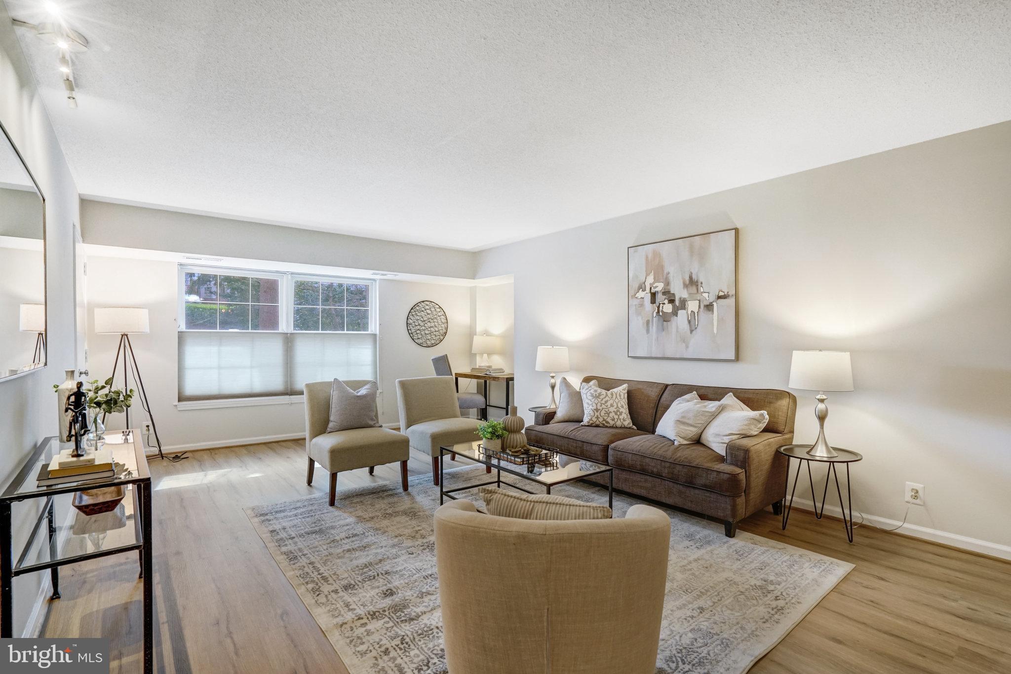 7640 Provincial Drive, Unit 109 McLean, VA 22102 - Photo 10 of 47 a living room with furniture and a large window