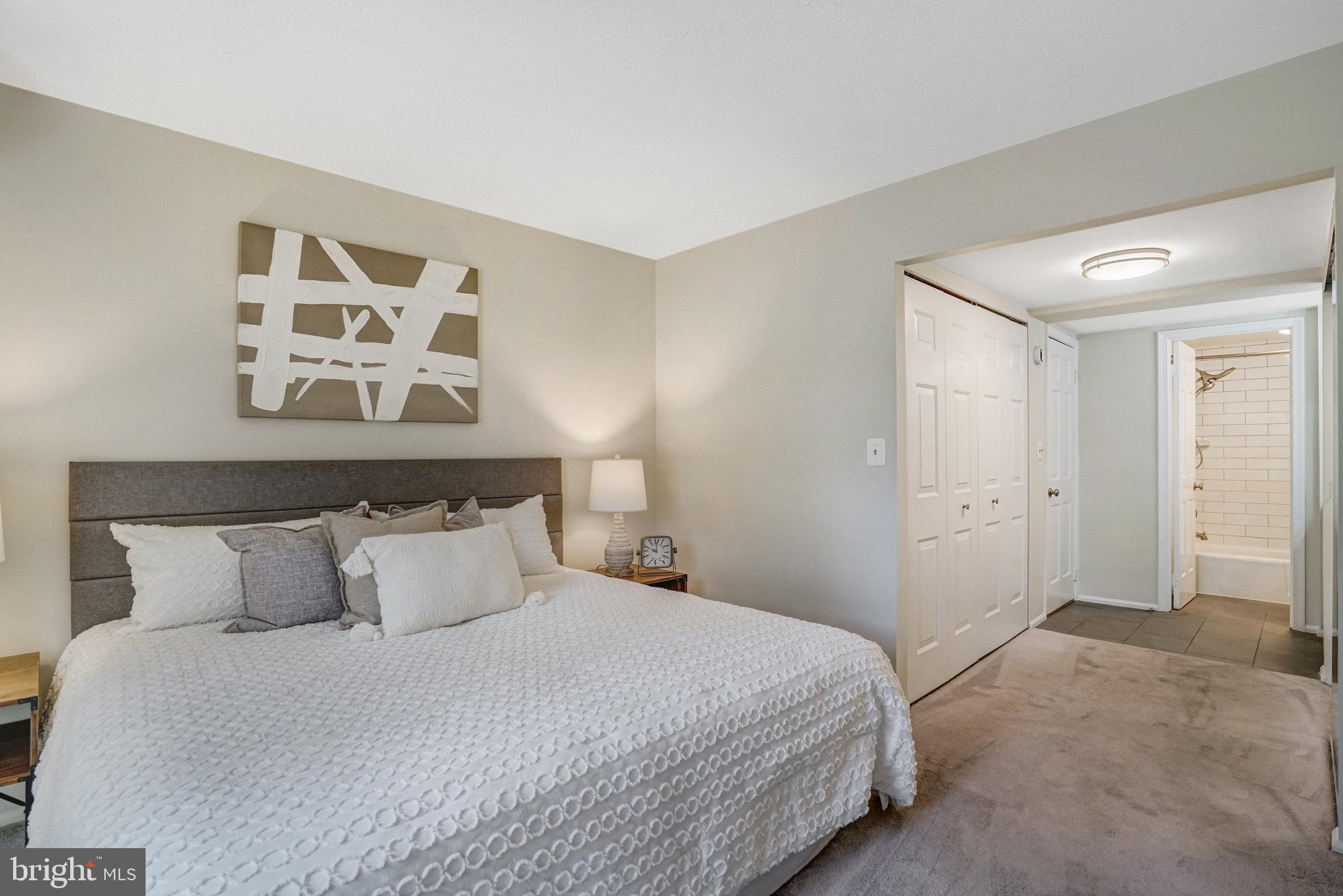 7640 Provincial Drive, Unit 109 McLean, VA 22102 - Photo 25 of 47 a bedroom with a bed and painting on the wall