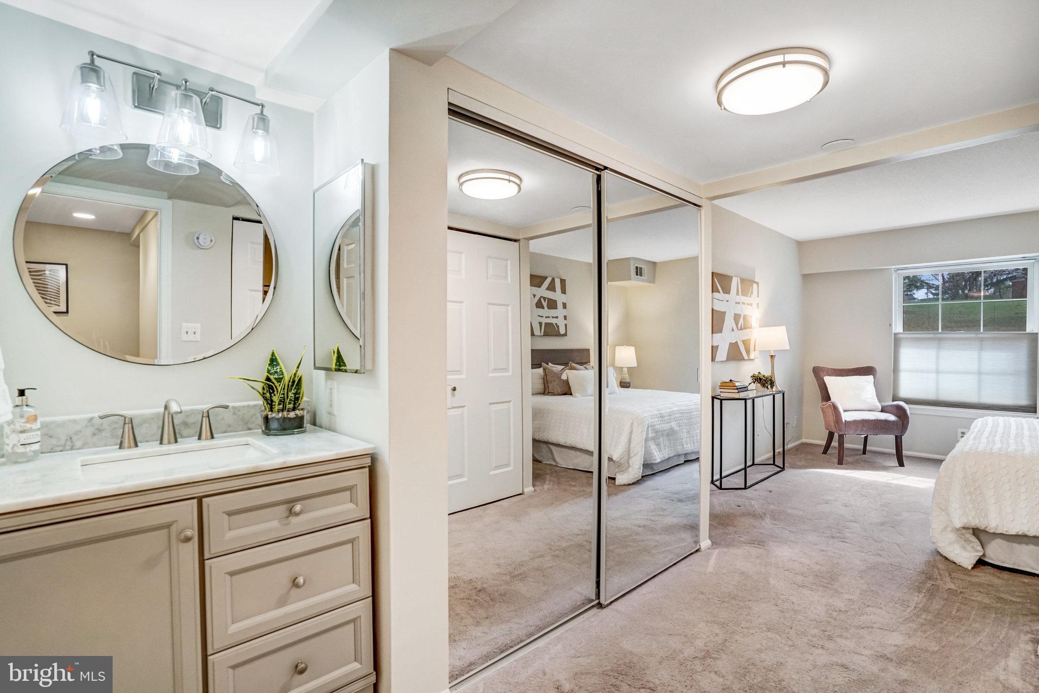 7640 Provincial Drive, Unit 109 McLean, VA 22102 - Photo 29 of 47 a en suite bathroom with a double vanity sink and a mirror