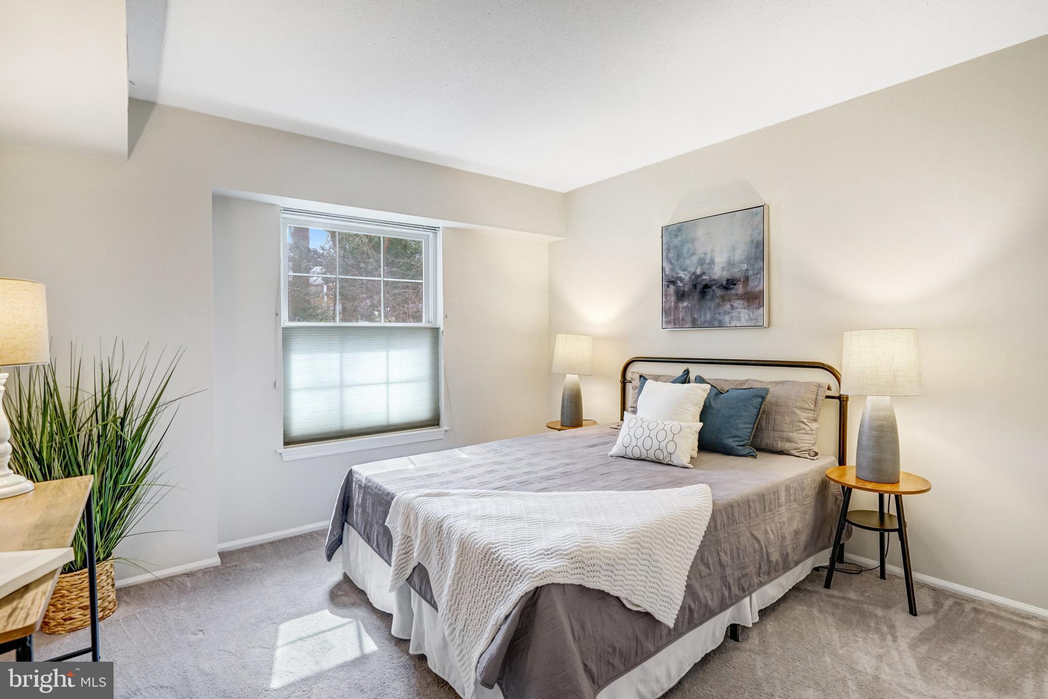 7640 Provincial Drive, Unit 109 McLean, VA 22102 - Photo 31 of 47 a bedroom with a bed and a potted plant