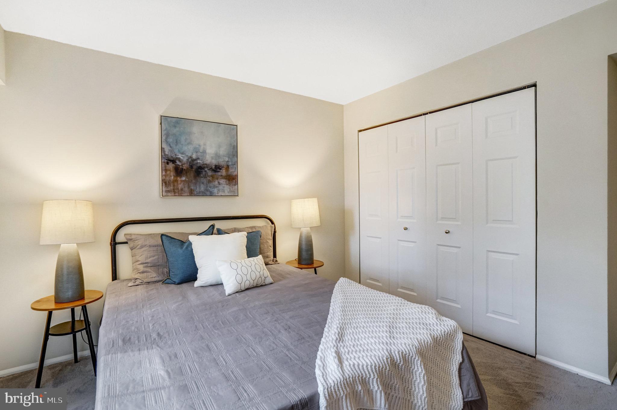 7640 Provincial Drive, Unit 109 McLean, VA 22102 - Photo 32 of 47 a bedroom with a bed and a painting on the wall