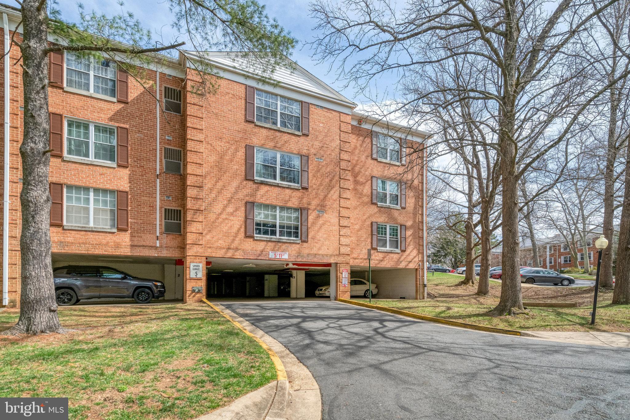 7640 Provincial Drive, Unit 109 McLean, VA 22102 - Photo 4 of 47 a front view of a building with a yard
