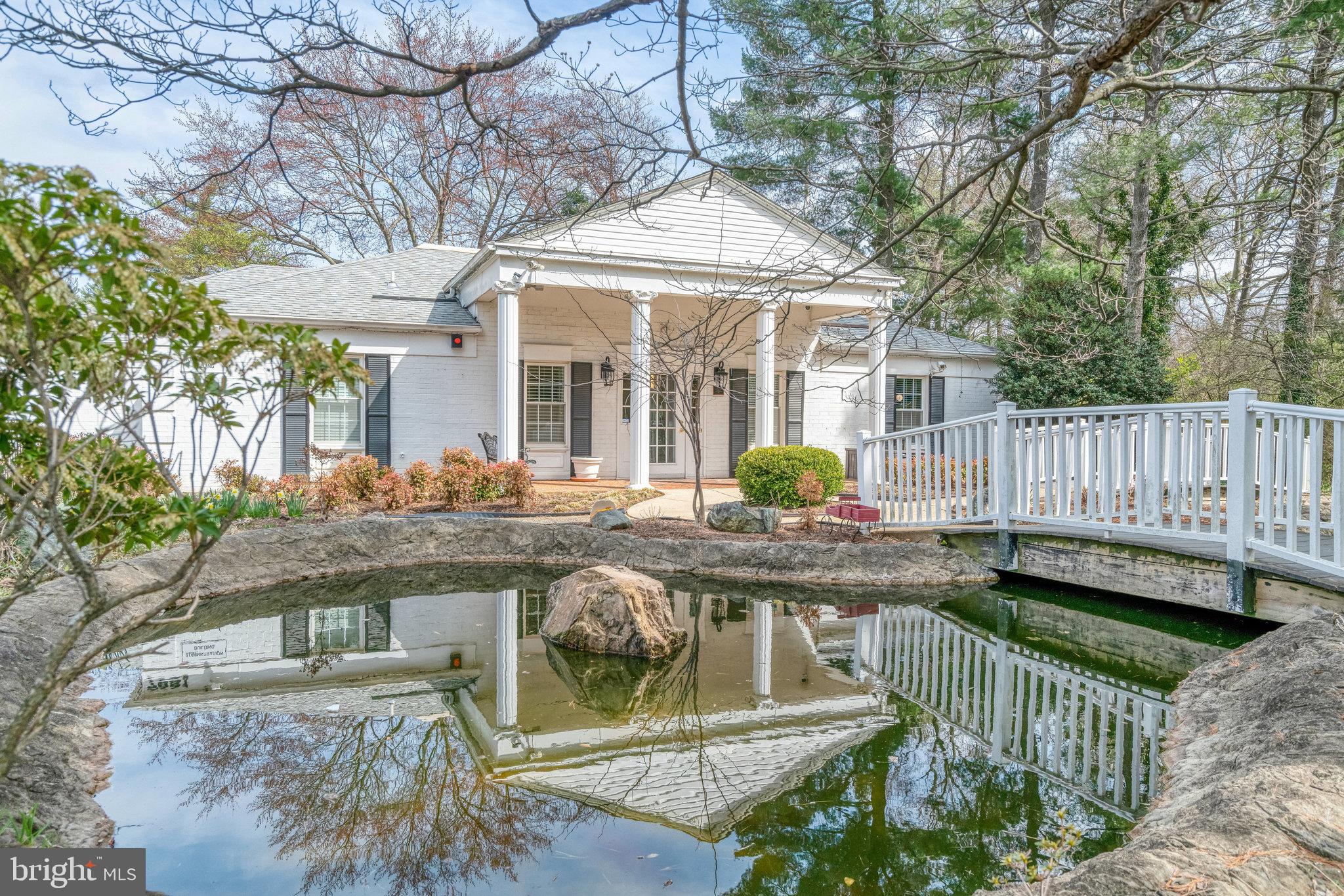 7640 Provincial Drive, Unit 109 McLean, VA 22102 - Photo 40 of 47 a view of a house with wooden deck and furniture