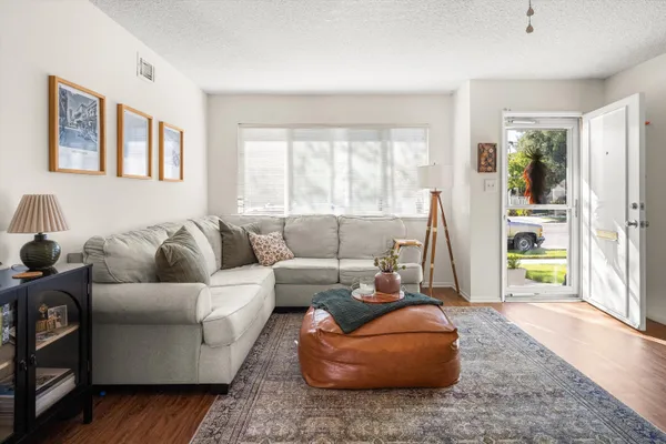 a living room with furniture and wooden floor