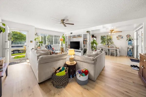 a kitchen with stainless steel appliances granite countertop a stove a sink dishwasher and cabinets with wooden floor