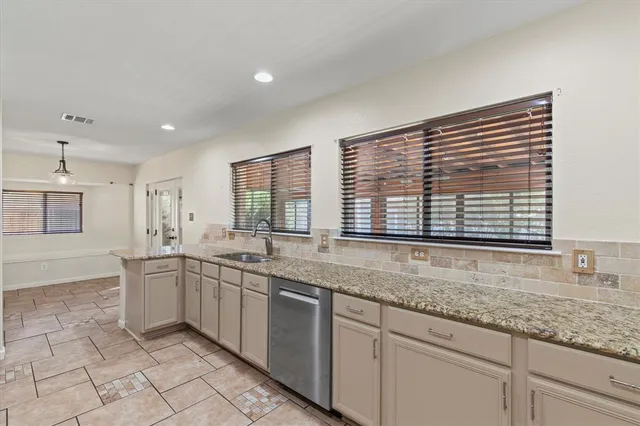 a kitchen with lots of counter space and windows