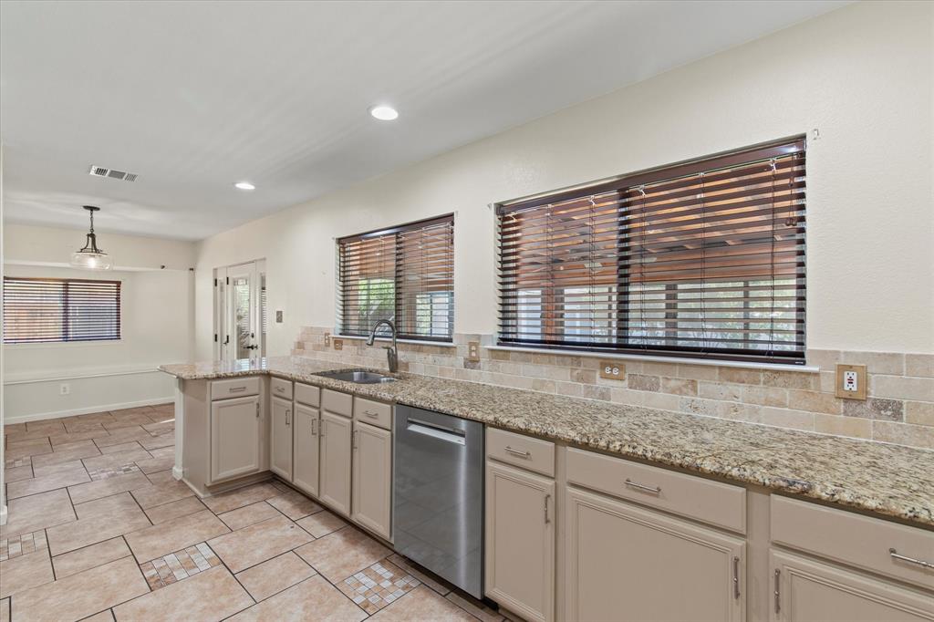 2201 Driskell Lane Corinth, TX 76210 - Photo 14 of 40 a kitchen with lots of counter space and windows