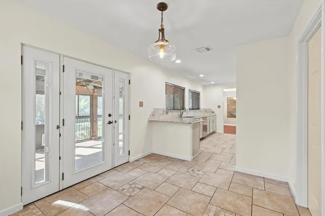 a view of a kitchen with refrigerator and windows