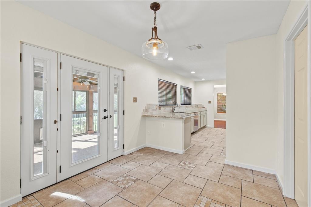 2201 Driskell Lane Corinth, TX 76210 - Photo 17 of 40 a view of a kitchen with refrigerator and windows