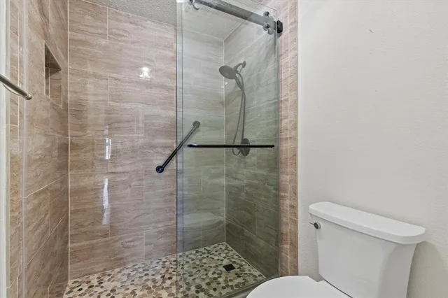 a bathroom with a shower and toilet