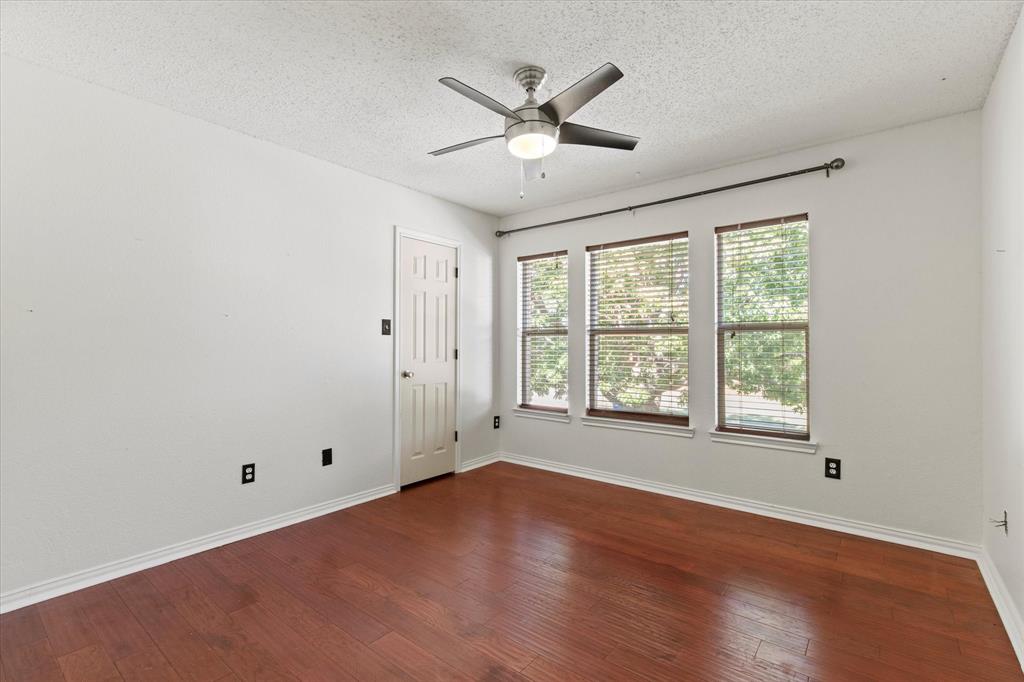 2201 Driskell Lane Corinth, TX 76210 - Photo 28 of 40 a view of an empty room with wooden floor and a window