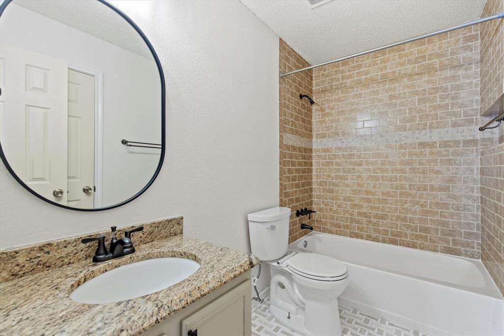 2201 Driskell Lane Corinth, TX 76210 - Photo 31 of 40 a bathroom with a sink toilet and shower