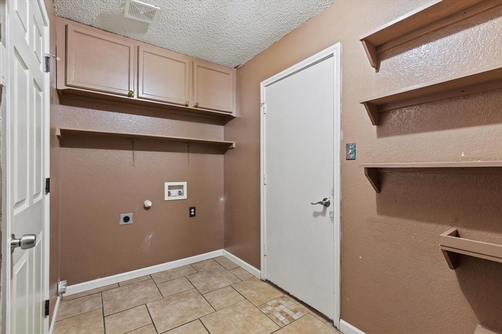 2201 Driskell Lane Corinth, TX 76210 - Photo 32 of 40 a view of a livingroom with wooden cabinets