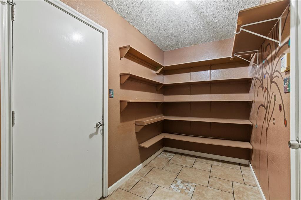 2201 Driskell Lane Corinth, TX 76210 - Photo 33 of 40 a view of walk in closet with empty racks