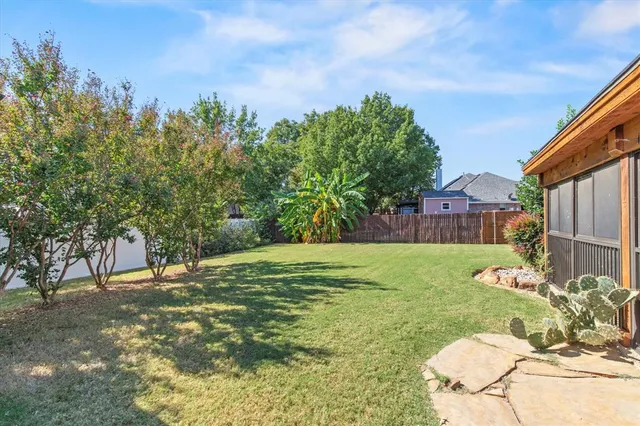 a view of big yard with a house in the background
