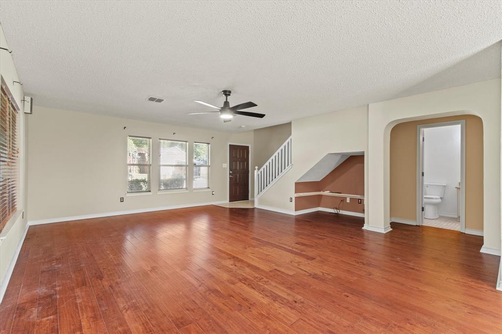 2201 Driskell Lane Corinth, TX 76210 - Photo 6 of 40 an empty room with wooden floor and windows