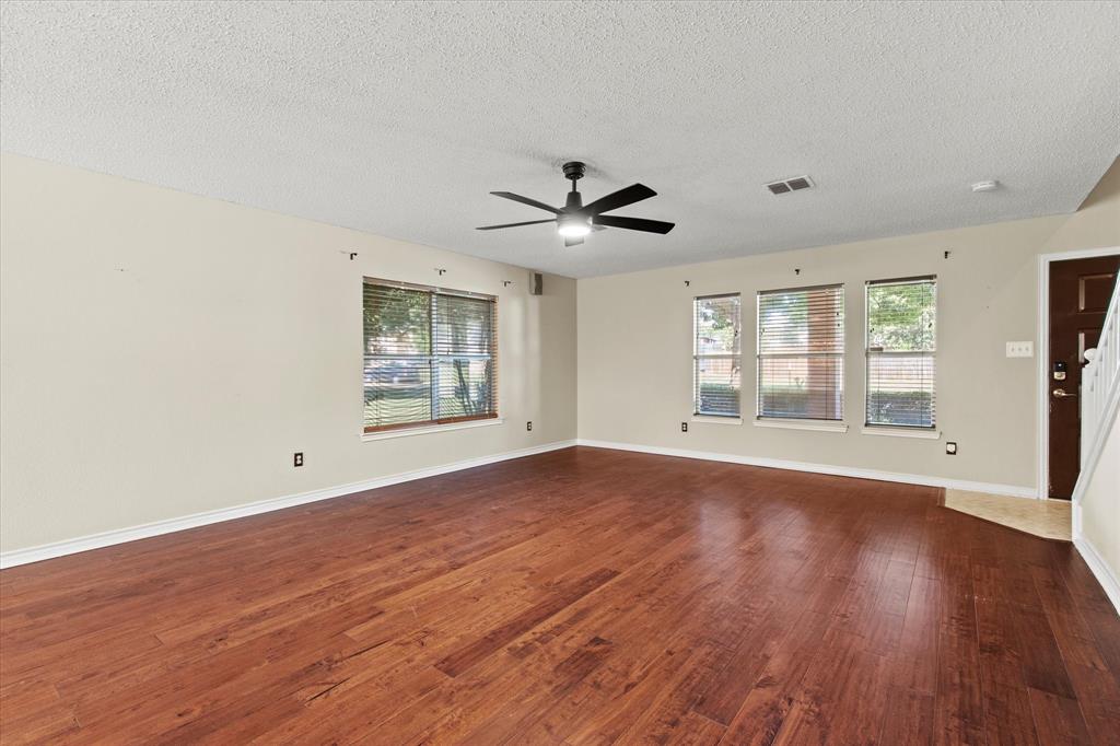 2201 Driskell Lane Corinth, TX 76210 - Photo 7 of 40 a view of an empty room with wooden floor and a window